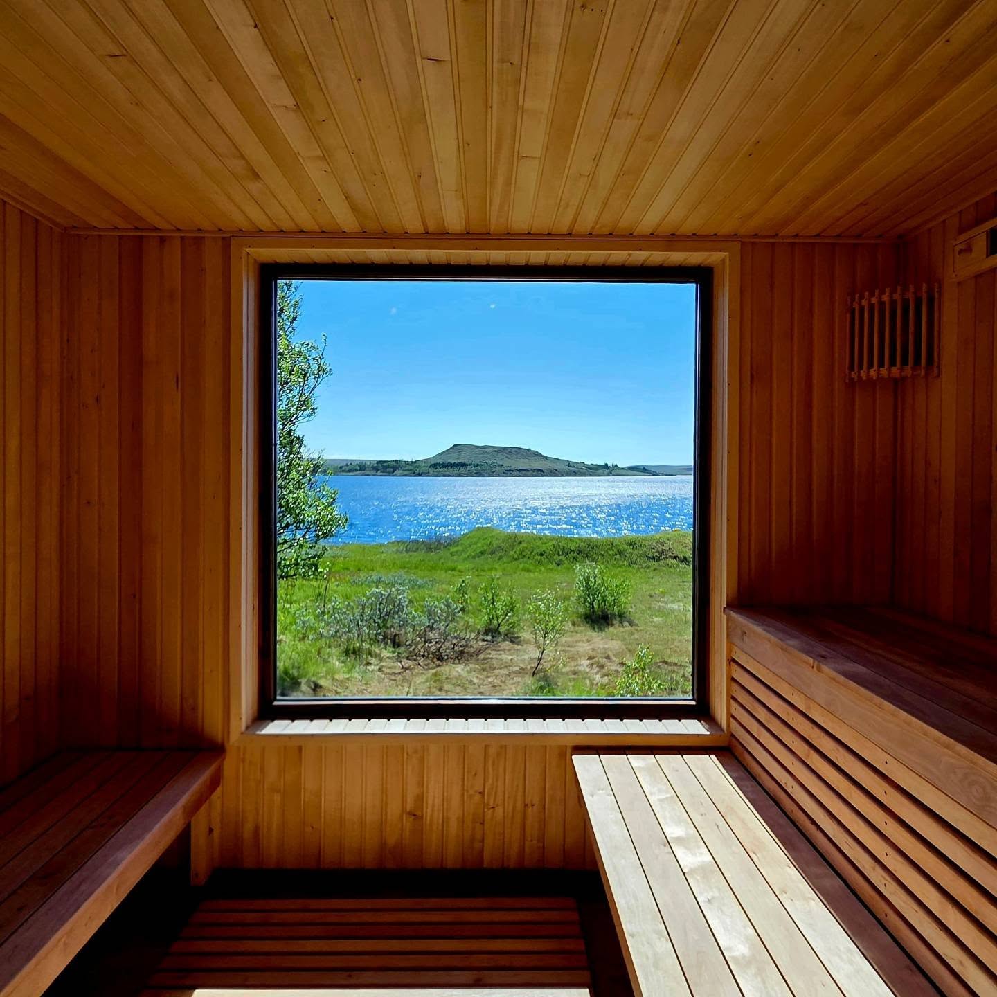 The lake-house sauna, with a picture window looking straight out over the water