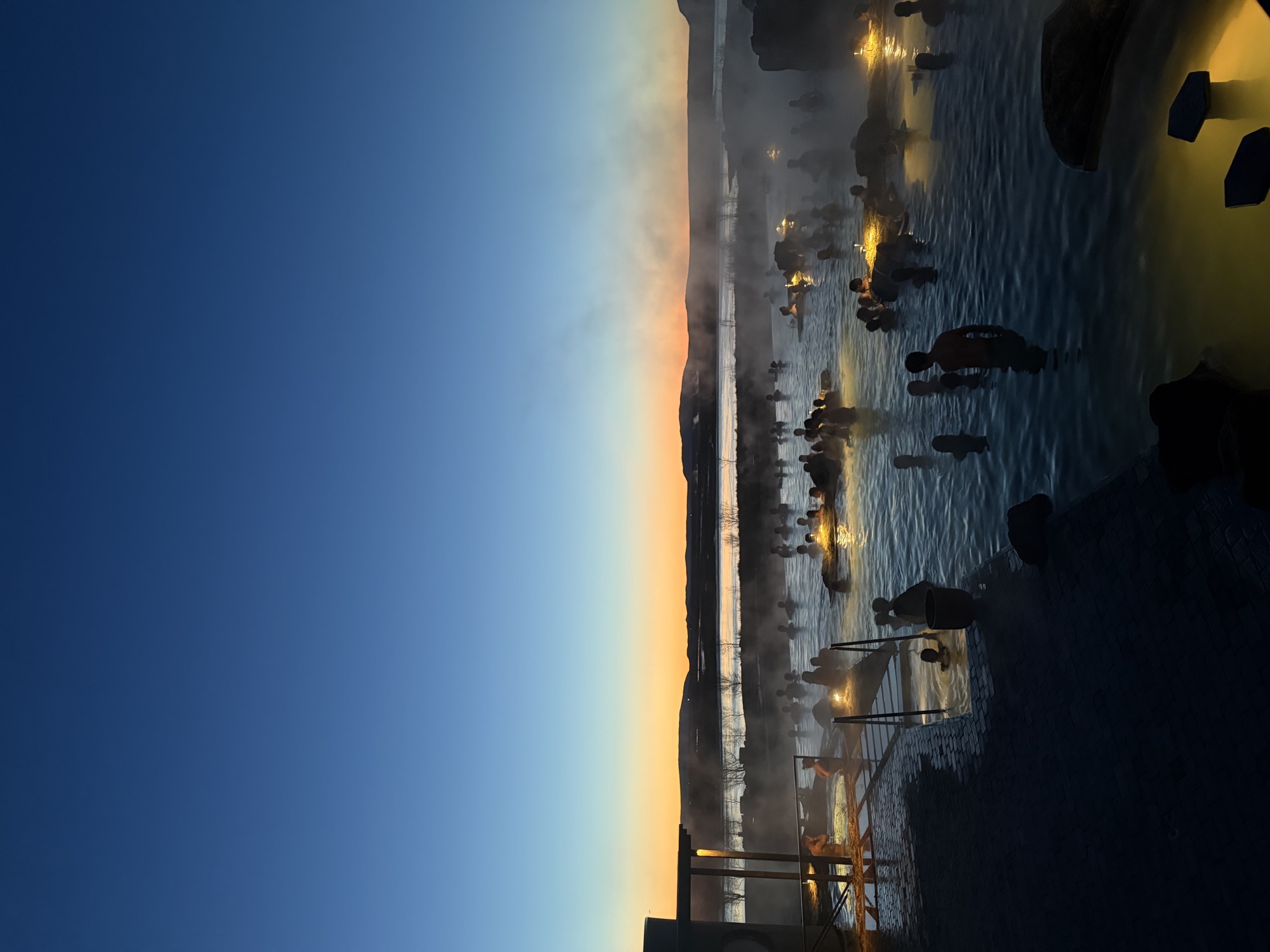 Bathing in a steaming geothermal lagoon at dusk